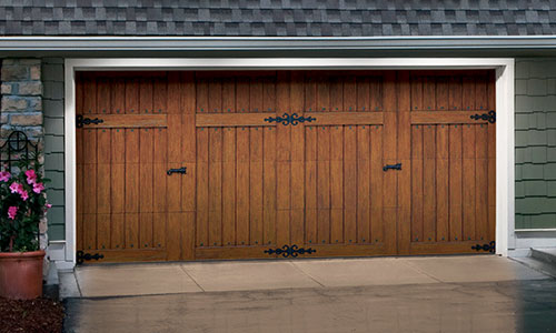 Boost your home’s value A beautiful garage door, like this brown wooden one, can really boost your home’s curb appeal — and resale value.